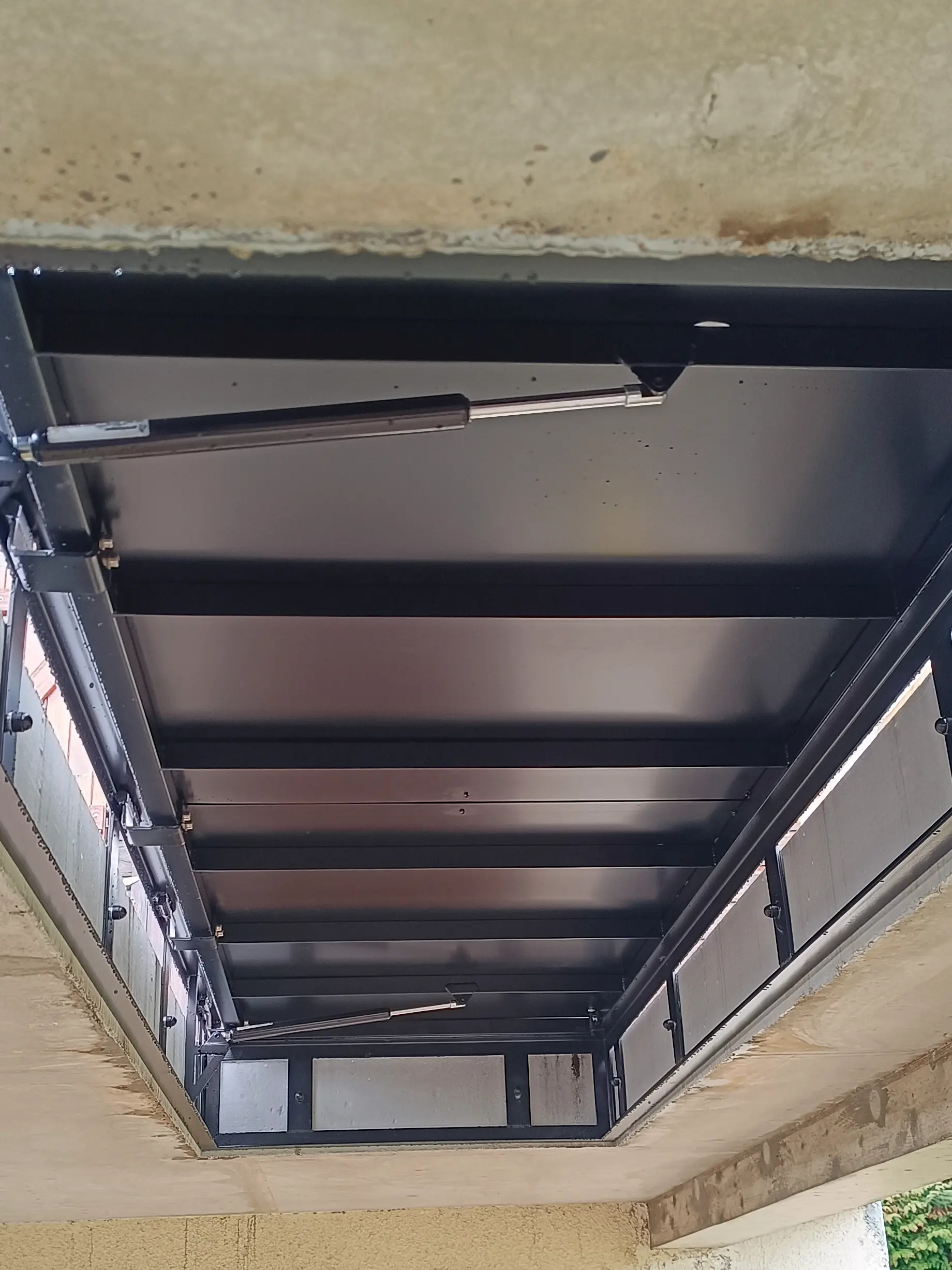 Trappe d’accès en acier sur mesure intégrée à une terrasse.